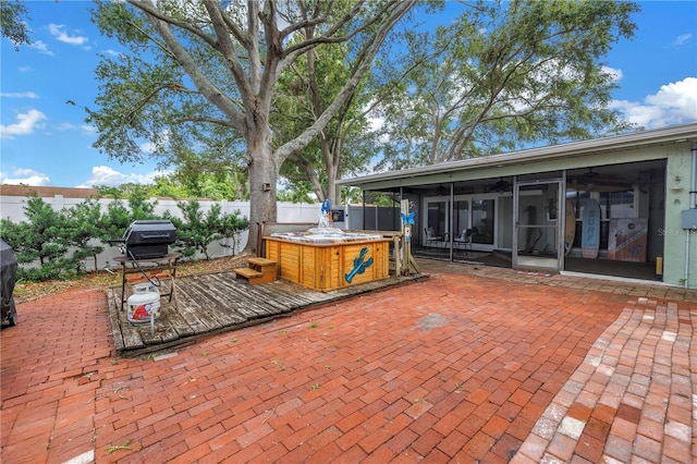 9611 107th Ave N, Largo, FL 33773 - fenced backyard with a sunroom, a ceiling fan, a patio, and a hot tub