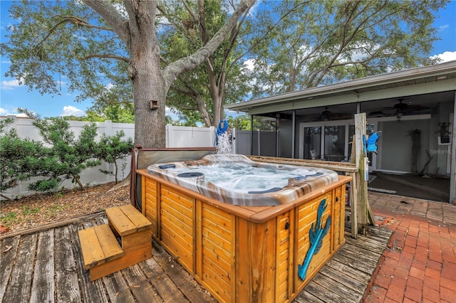 9611 107th Ave N, Largo, FL 33773 - deck with a hot tub, a fenced backyard, a ceiling fan, and a sunroom