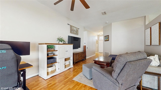 19635 Bellehurst Loop, Land O Lakes, FL 34638 - living room featuring a ceiling fan, light wood-style floors, baseboards, and vaulted ceiling