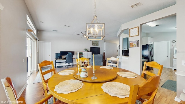 19635 Bellehurst Loop, Land O Lakes, FL 34638 - dining room with light wood-style flooring, a chandelier, and baseboards