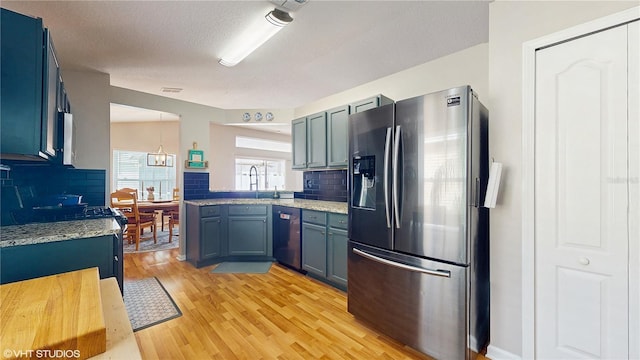 19635 Bellehurst Loop, Land O Lakes, FL 34638 - kitchen with stainless steel refrigerator with ice dispenser, dishwasher, decorative backsplash, and light wood-style flooring