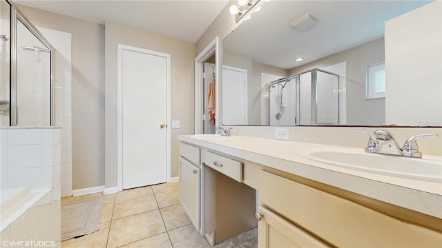 19635 Bellehurst Loop, Land O Lakes, FL 34638 - full bath with a stall shower, double vanity, tile patterned flooring, and tiled tub