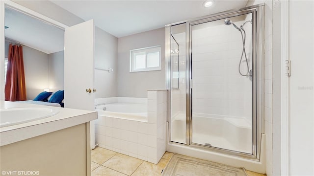 19635 Bellehurst Loop, Land O Lakes, FL 34638 - bathroom featuring a stall shower, a bath, tile patterned floors, vanity, and recessed lighting