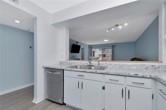 6817 Stones Throw Cir N Unit 17203, Saint Petersburg, FL 33710 - kitchen with dishwasher, a sink, light wood-style flooring, baseboards, and white cabinetry