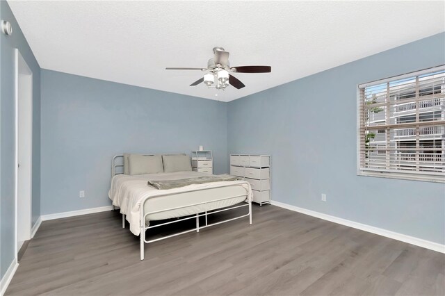 6817 Stones Throw Cir N Unit 17203, Saint Petersburg, FL 33710 - bedroom with wood finished floors, baseboards, and a ceiling fan