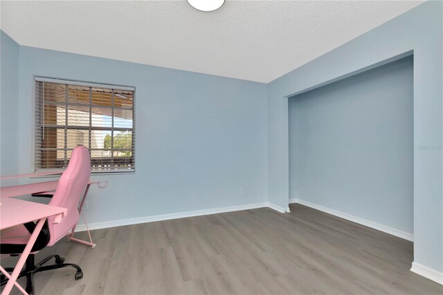6817 Stones Throw Cir N Unit 17203, Saint Petersburg, FL 33710 - unfurnished office featuring wood finished floors, baseboards, and a textured ceiling
