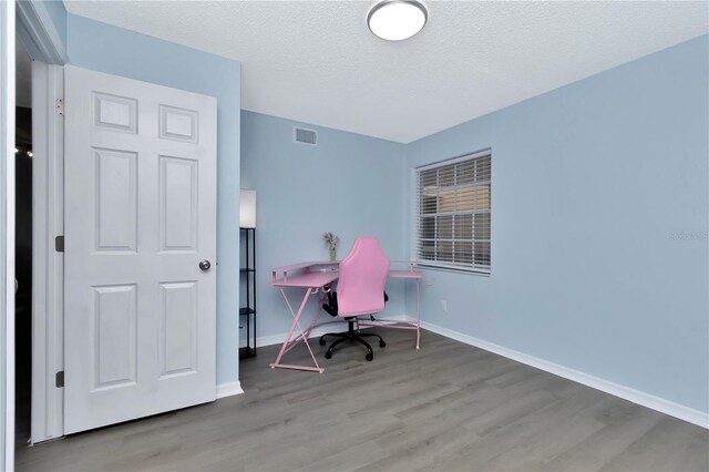 6817 Stones Throw Cir N Unit 17203, Saint Petersburg, FL 33710 - office area with wood finished floors, baseboards, and a textured ceiling