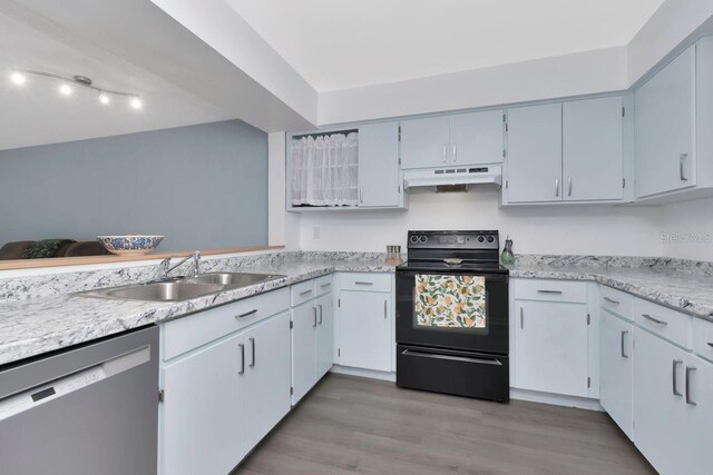 6817 Stones Throw Cir N Unit 17203, Saint Petersburg, FL 33710 - kitchen with black electric range oven, dishwasher, under cabinet range hood, a sink, and light wood finished floors
