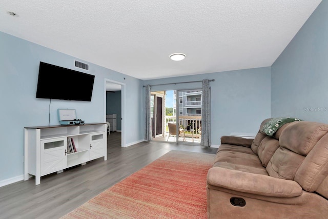 6817 Stones Throw Cir N Unit 17203, Saint Petersburg, FL 33710 - living room featuring wood finished floors, baseboards, and a textured ceiling