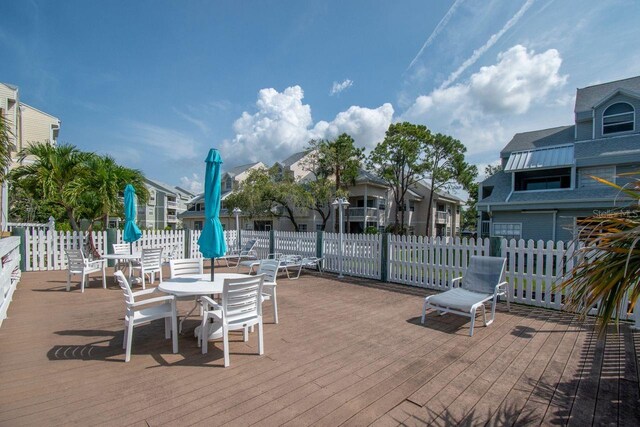 6817 Stones Throw Cir N Unit 17203, Saint Petersburg, FL 33710 - wooden terrace with outdoor dining area and a residential view