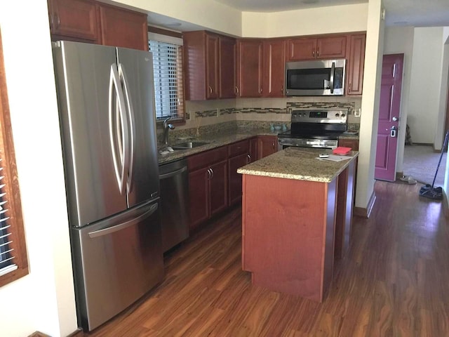 5310 Pebble Beach Dr Unit F, Orlando, FL 32811 - kitchen with stainless steel appliances, a sink, dark wood-style flooring, and a center island