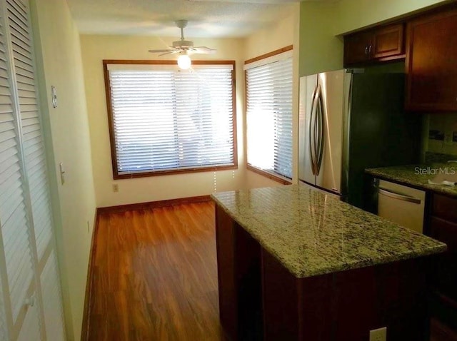 5310 Pebble Beach Dr Unit F, Orlando, FL 32811 - kitchen with dishwasher, ceiling fan, wood finished floors, stone counters, and freestanding refrigerator
