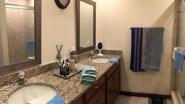 5310 Pebble Beach Dr Unit F, Orlando, FL 32811 - bathroom with double vanity, a shower stall, and tile patterned flooring