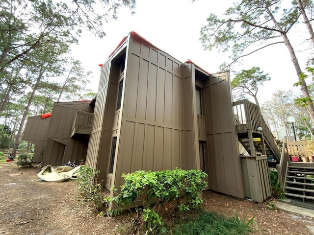 5310 Pebble Beach Dr Unit F, Orlando, FL 32811 - view of side of property with stairs and board and batten siding