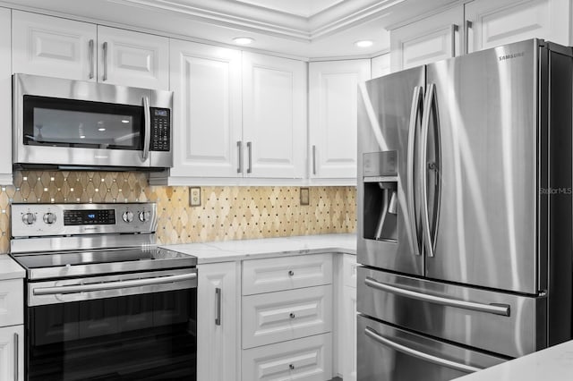 17920 Gulf Blvd Unit 1901, Redington Shores, FL 33708 - kitchen featuring stainless steel appliances, white cabinetry, decorative backsplash, light stone countertops, and recessed lighting