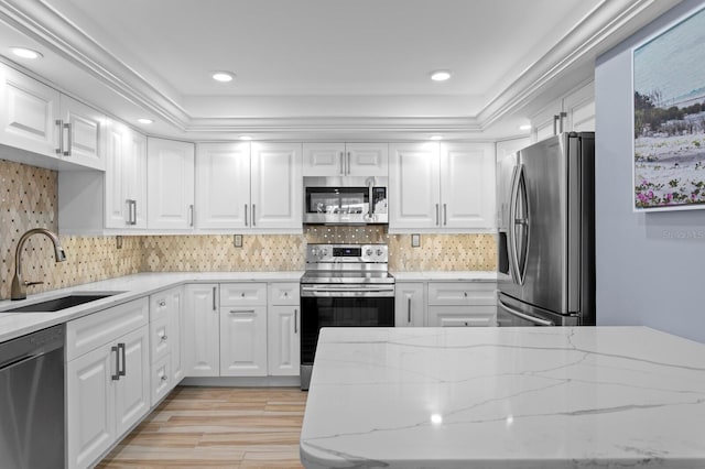 17920 Gulf Blvd Unit 1901, Redington Shores, FL 33708 - kitchen with appliances with stainless steel finishes, a sink, white cabinetry, light wood-style flooring, and recessed lighting