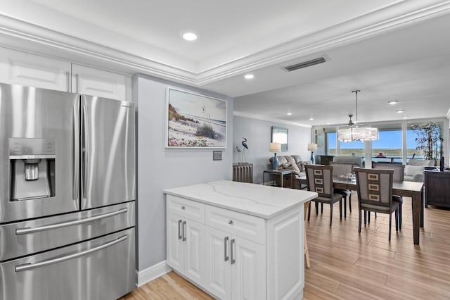 17920 Gulf Blvd Unit 1901, Redington Shores, FL 33708 - kitchen with stainless steel refrigerator with ice dispenser, open floor plan, light stone countertops, light wood-style flooring, and white cabinetry