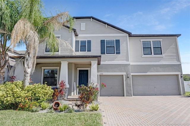11726 Sunburst Marble Rd, Riverview, FL 33579 - view of front of home featuring a garage, stucco siding, and decorative driveway