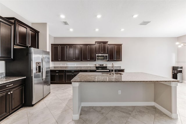 11726 Sunburst Marble Rd, Riverview, FL 33579 - kitchen with appliances with stainless steel finishes, a sink, stone countertops, a center island with sink, and recessed lighting