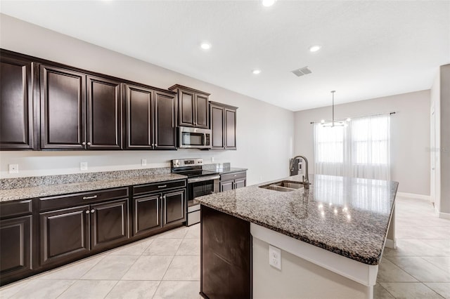 11726 Sunburst Marble Rd, Riverview, FL 33579 - kitchen with appliances with stainless steel finishes, a sink, light tile patterned floors, light stone counters, and an island with sink