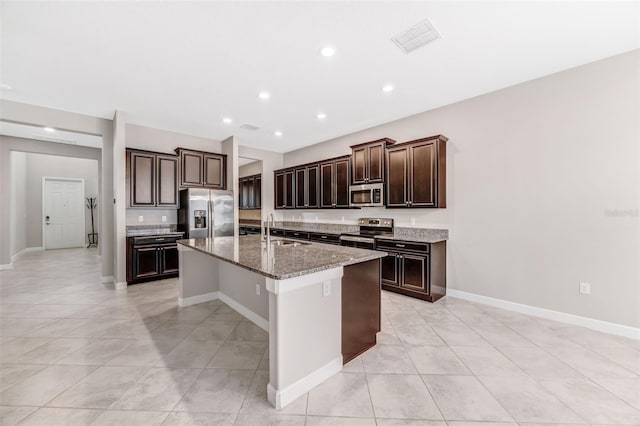 11726 Sunburst Marble Rd, Riverview, FL 33579 - kitchen with stainless steel appliances, a sink, an island with sink, light tile patterned floors, and recessed lighting