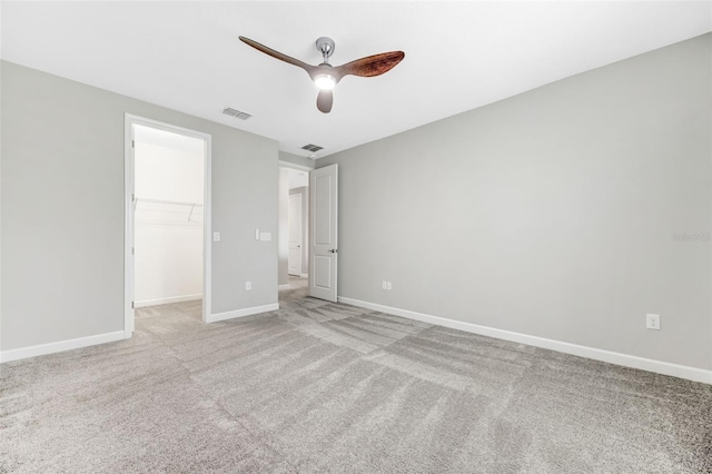 11726 Sunburst Marble Rd, Riverview, FL 33579 - unfurnished bedroom with light colored carpet, a walk in closet, baseboards, and ceiling fan