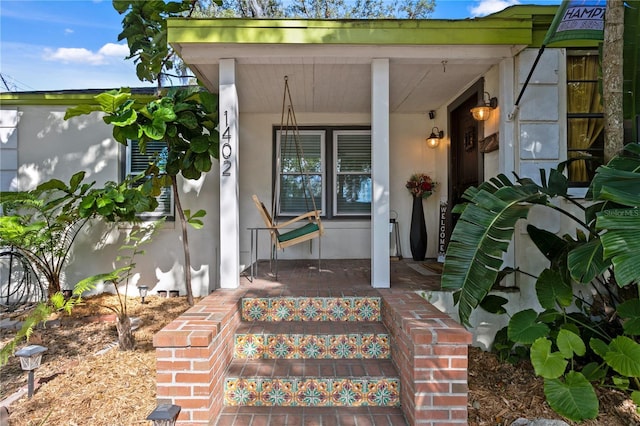 1402 E Mohawk Ave, Tampa, FL 33604 - entrance to property featuring covered porch and stucco siding