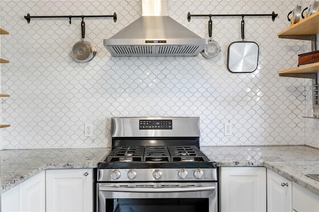 1402 E Mohawk Ave, Tampa, FL 33604 - kitchen with open shelves, stainless steel range with gas cooktop, wall chimney exhaust hood, white cabinetry, and light stone countertops