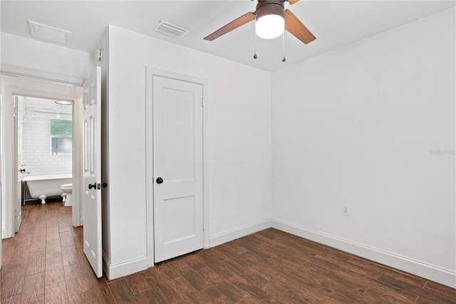 1402 E Mohawk Ave, Tampa, FL 33604 - unfurnished bedroom with dark wood finished floors, baseboards, and ceiling fan