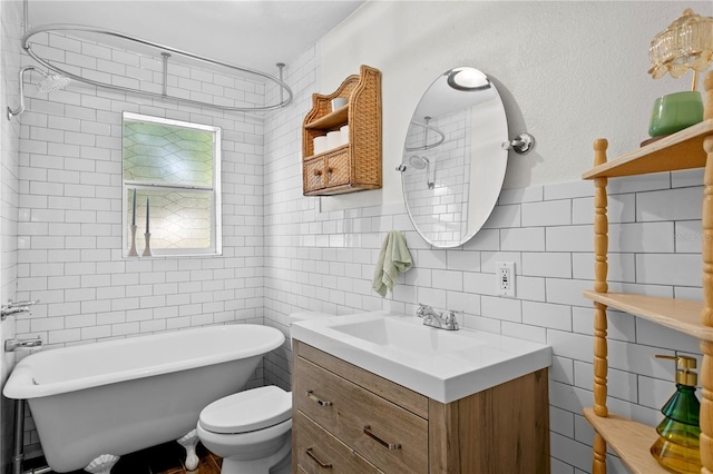 1402 E Mohawk Ave, Tampa, FL 33604 - bathroom with a freestanding tub, tile walls, vanity, and toilet