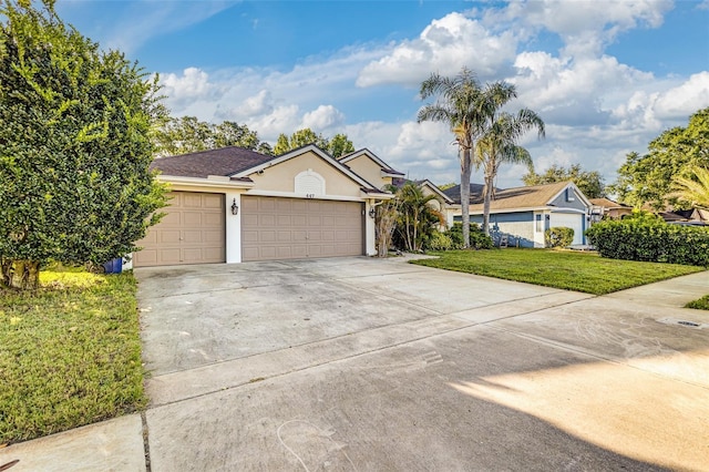 447 Bridle Path Way, Tarpon Springs, FL 34688 - ranch-style house with stucco siding, driveway, a front yard, and an attached garage