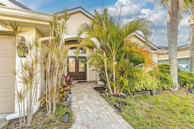 447 Bridle Path Way, Tarpon Springs, FL 34688 - view of exterior entry with french doors and stucco siding