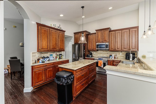 447 Bridle Path Way, Tarpon Springs, FL 34688 - kitchen featuring stainless steel appliances, a sink, light stone counters, backsplash, and dark wood-style flooring