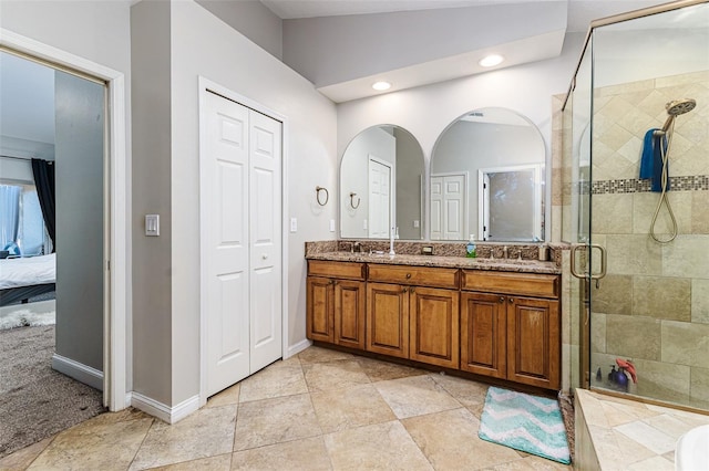 447 Bridle Path Way, Tarpon Springs, FL 34688 - full bath with double vanity, a stall shower, a closet, connected bathroom, and recessed lighting