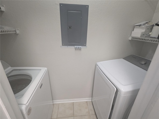 1216 S Missouri Ave Unit 223, Clearwater, FL 33756 - laundry area with electric panel, washer and clothes dryer, baseboards, and tile patterned floors