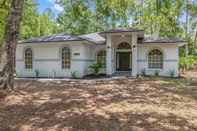 7644 Conrad St, Wesley Chapel, FL 33544 - view of front facade featuring stucco siding and roof with shingles