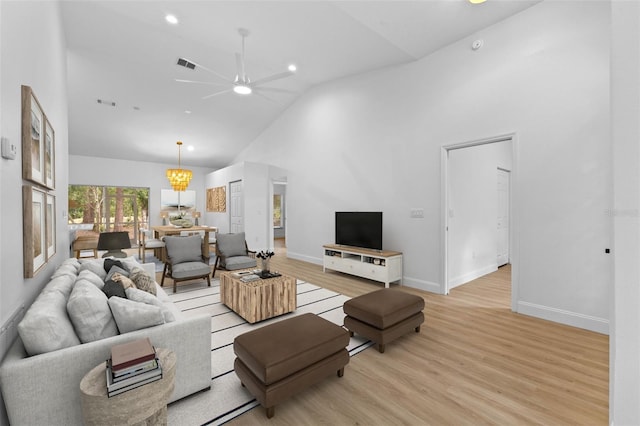 7644 Conrad St, Wesley Chapel, FL 33544 - living area with a ceiling fan, light wood-style flooring, high vaulted ceiling, baseboards, and recessed lighting