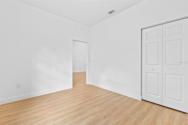 7644 Conrad St, Wesley Chapel, FL 33544 - unfurnished bedroom featuring light wood-style flooring, baseboards, and a closet