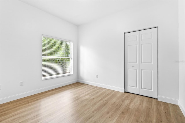 7644 Conrad St, Wesley Chapel, FL 33544 - unfurnished bedroom featuring light wood-style floors, baseboards, and a closet