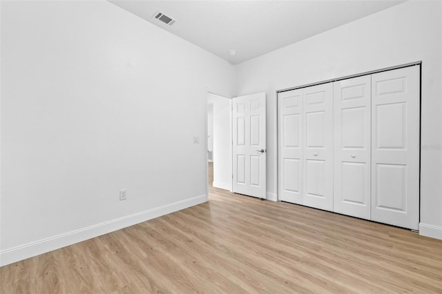 7644 Conrad St, Wesley Chapel, FL 33544 - unfurnished bedroom with light wood-style flooring, baseboards, and a closet