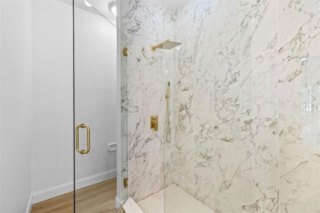 7644 Conrad St, Wesley Chapel, FL 33544 - full bathroom with a marble finish shower, wood finished floors, and baseboards