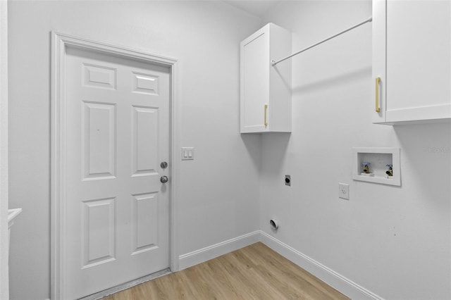 7644 Conrad St, Wesley Chapel, FL 33544 - washroom with hookup for an electric dryer, light wood-type flooring, cabinet space, hookup for a washing machine, and baseboards