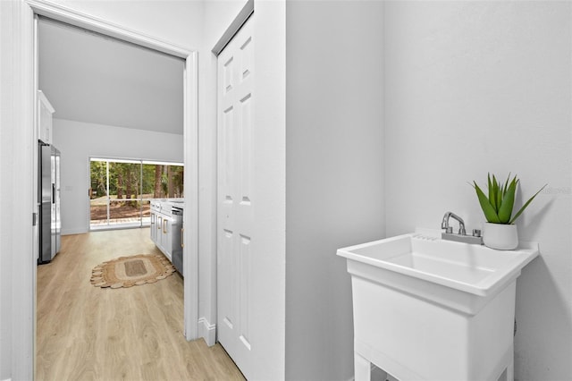 7644 Conrad St, Wesley Chapel, FL 33544 - washroom with light wood finished floors and a sink