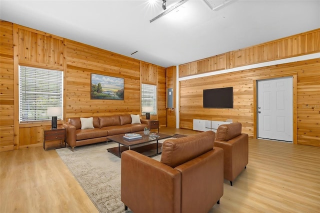 7644 Conrad St, Wesley Chapel, FL 33544 - living room featuring wood walls, plenty of natural light, light wood-style flooring, and attic access