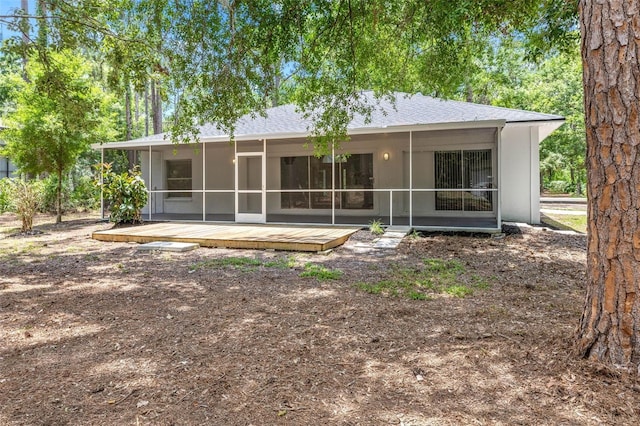 7644 Conrad St, Wesley Chapel, FL 33544 - back of property with a sunroom, a deck, and stucco siding