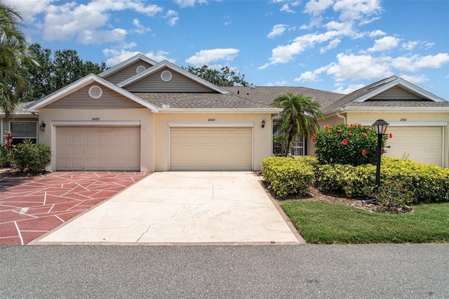 2403 Nantucket Field Way Unit 27, Sun City Center, FL 33573 - ranch-style house featuring a shingled roof, stucco siding, concrete driveway, and an attached garage
