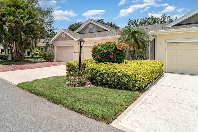 2403 Nantucket Field Way Unit 27, Sun City Center, FL 33573 - single story home featuring stucco siding, a shingled roof, concrete driveway, and an attached garage