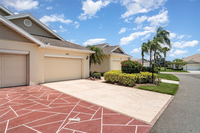 2403 Nantucket Field Way Unit 27, Sun City Center, FL 33573 - view of front of property with stucco siding, driveway, and a shingled roof