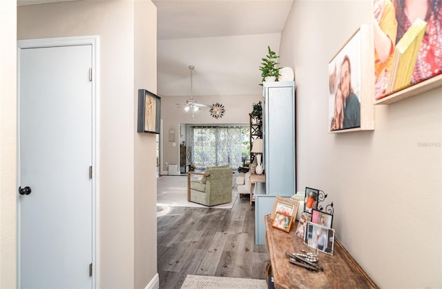 2403 Nantucket Field Way Unit 27, Sun City Center, FL 33573 - corridor featuring wood finished floors, vaulted ceiling, and baseboards