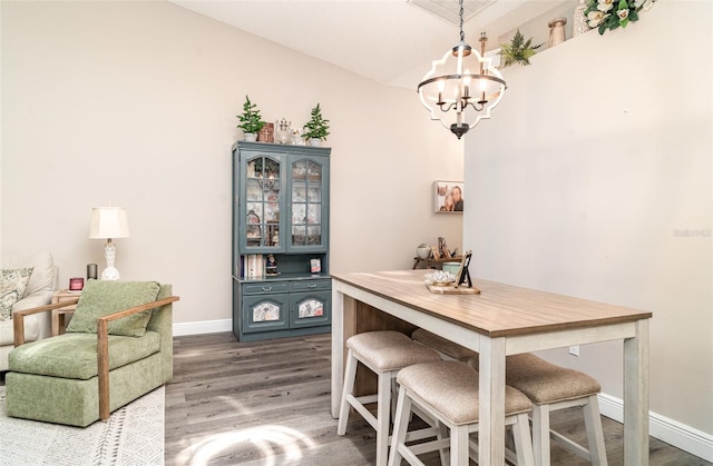 2403 Nantucket Field Way Unit 27, Sun City Center, FL 33573 - dining space with a chandelier, wood finished floors, baseboards, and lofted ceiling